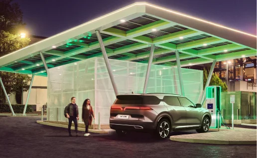 A gray VF 9 is parked at a Level 3 DC Fast Charging station at night for quick charging