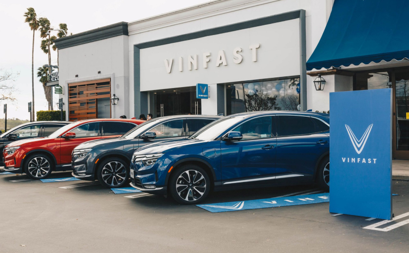 VinFast showroom featuring vehicles in red, black, and blue, highlighting durability and confidence with the 10-year car warranty