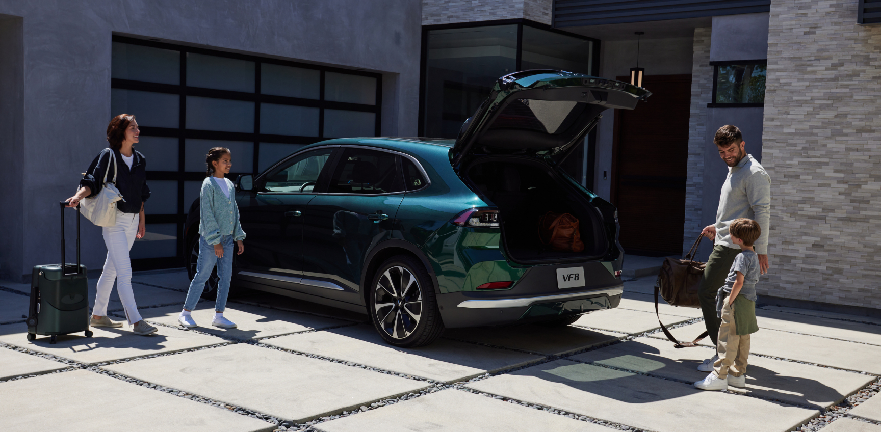 Green VinFast electric vehicle parked near a mountain home, showcasing reliability and peace of mind with its robust electric vehicle battery warranty