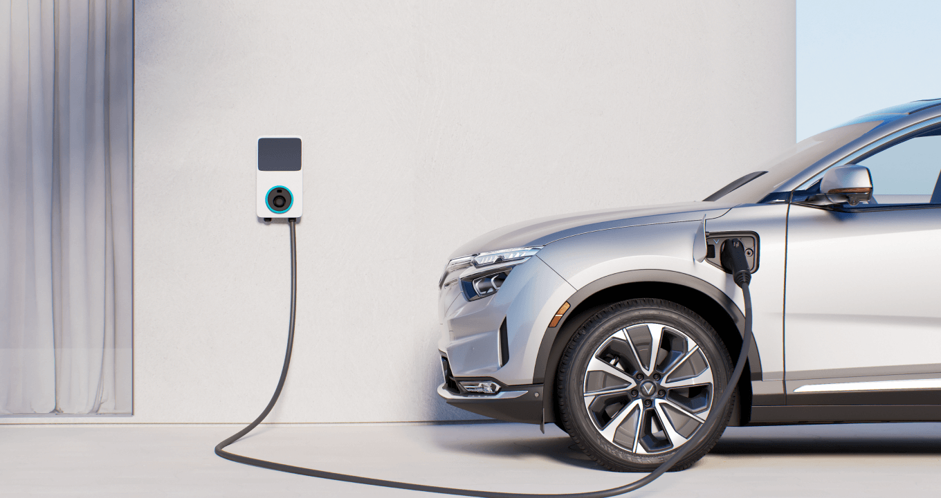 A silver VF 8 is plugged into a home charging system for electric vehicles